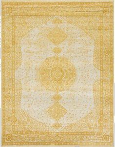 a yellow and white rug with an intricate design on the bottom, in front of a white background