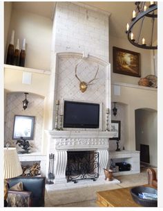 a living room filled with furniture and a flat screen tv on top of a fireplace