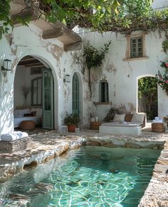 an outdoor living area with a pool in the middle