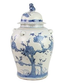 a blue and white vase with a tree on it