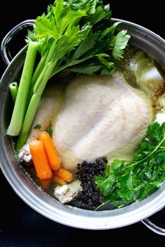 chicken, carrots and celery are in a pot