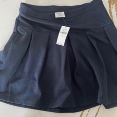 Brand New (Never Worn) Navy Blue Gap School Uniform Skirt. Size M (8). Casual Navy Skort With Lined Skirt, Casual Navy Lined Skort, Casual Navy Tennis Skirt For Spring, Navy Casual Pleated Skirt Skort, Casual Navy Pleated Skort, Navy Casual Pleated Skort, Navy Casual Tennis Skirt, Blue Cotton Skort For School Uniform, Blue Stretch Skort For School