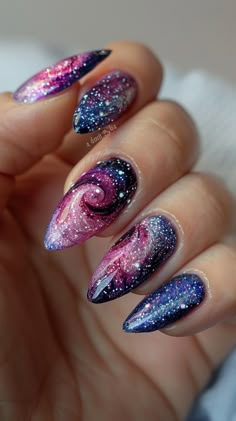 Embrace the cosmic trend with a dazzling galaxy-inspired manicure. Start with a deep pink base and then layer on swirls of glitter polish in shades of silver, blue, and purple to mimic the appearance of a starry night sky. Space Themed Nails Acrylic, Galaxy Inspired Nails, Galaxy Nails Designs, Outer Space Nails, Purple Galaxy Nails, Galaxy Nail Designs, Night Sky Nails, Nail Art Galaxy, Magical Nails