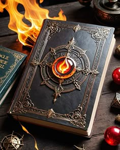 a book sitting on top of a wooden table next to candles and other items in front of it