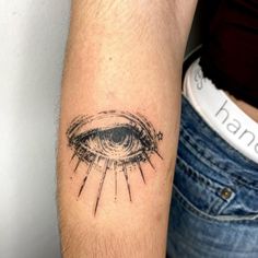 a person with a tattoo on their arm and an eye in the middle of it