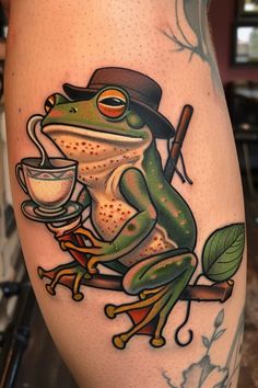 a frog with a hat on its head sitting on a branch holding a coffee cup