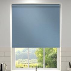 a blue roller shade in a kitchen window