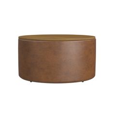 a brown leather ottoman sitting on top of a wooden table