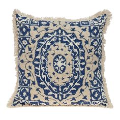 a blue and white pillow with fringes on the front, featuring an intricate design