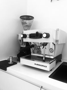 a black and white photo of a coffee machine