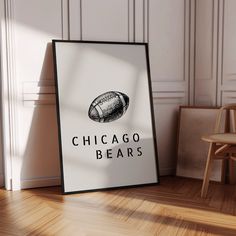 a chicago bears football poster on the floor next to a wooden chair and wall with white paneling