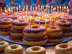 there are many donuts with candles on them