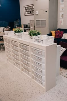 several plastic bins are stacked on top of each other in the middle of a room