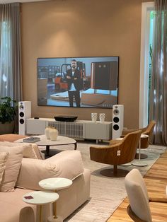 a living room filled with furniture and a flat screen tv mounted to the side of a wall