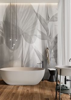 a white bath tub sitting next to a sink in a room with wood flooring