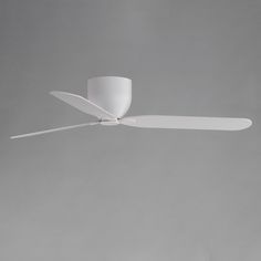 a white ceiling fan on a gray wall