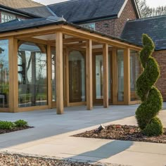 an outside view of a house with wooden pillars and glass doors on the front door