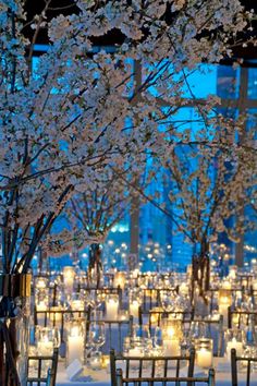 the tables are set with candles and centerpieces for an elegant wedding reception in new york city