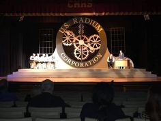 the stage is set for an event with people sitting on it