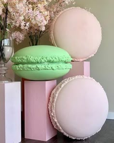 three different colored plates and vases sitting on top of each other in front of flowers