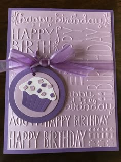 a purple birthday card with a cupcake on it and a ribbon around the edge