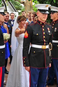 a bride and groom standing next to each other in front of a group of people