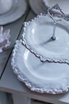 a table topped with white plates and silverware