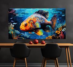 a painting of a goldfish on a wall above two black chairs in front of a wooden table