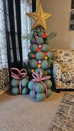 a christmas tree made out of balloons and bows