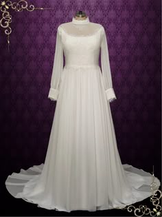 a white wedding dress on display in front of a purple wall