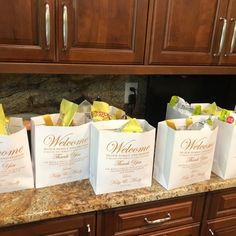 four white bags sitting on top of a counter