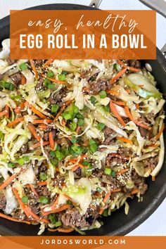 an egg roll in a bowl with carrots, cabbage and green onions on top