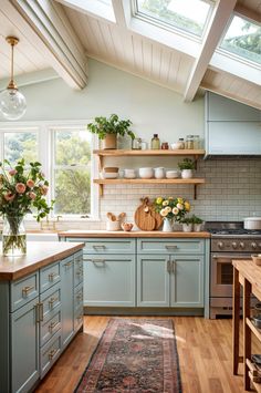 a kitchen filled with lots of counter space next to a wooden floor covered in plants