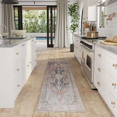 a kitchen with an area rug on the floor