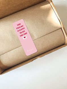 an open cardboard box with a pink sticker on the side that says, this package is happy to see you today