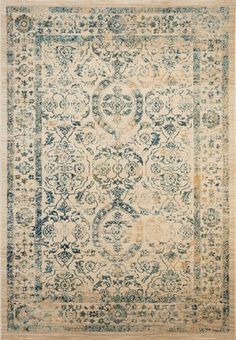 an antique rug with blue and beige colors