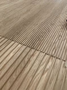 a skateboarder doing a trick on the wooden floor