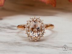 a fancy ring with an oval cut diamond surrounded by small white and yellow diamonds on top