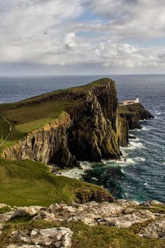 a lighthouse on top of a cliff near the ocean