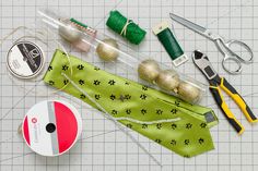 sewing supplies laid out on top of a piece of paper with scissors, tape and thread