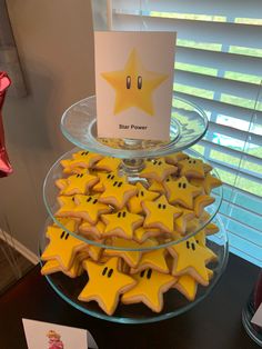 some cookies are arranged in the shape of stars on a glass platter with a sign that says star power