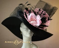 Looks elegant and beautiful from all angles.  Pretty pink floral with loads of fluttering black feathers. Teamed with delicious layers of tulle, netting, and crinoline. Customization is available; please inquire to see if we can meet your needs. Perfect for Kentucky Derby, Del Mar Races, Melbourne Cup, Royal Ascot, Breeders' Cup, Hat Contests, Church, Gala, Derby, Cocktail, High Tea, Weddings, Preakness, and more.   *FREE SHIPPING  Though often copied by hobbyists and even high-end department stores, discriminating fashionistas from all walks of life count on Aimee's pieces to lead the trends and make one-of-a-kind statements in their ensembles, fashion shoots, and style shows. You can also see her designs on everyone from judges to Real Housewives; from news anchors to Hollywood stylists; Luxury Pink Top Hat For Spring, Black Hat For Garden Party In Spring, Elegant Hat, Black Wide Brim Hat For Garden Party, Black High Crown Top Hat For Spring, Elegant Black Hat For Garden Party, Black Mini Hat With Curved Brim For Garden Party, Black Hat For Kentucky Derby Garden Party, Elegant Black Hats For Garden Party