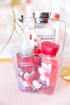 two bottles of body lotion sitting on top of a table