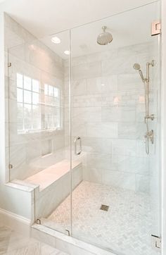 a bathroom with a walk in shower next to a sink