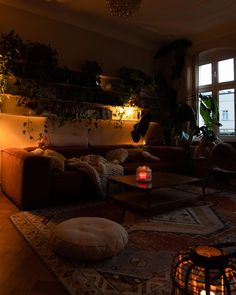 a living room filled with lots of furniture next to a window