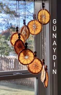 an orange slice hanging from a window with the words gumpydinn on it