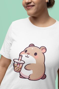 "Sip in style with this charming unisex T-shirt featuring a delightful capybara cozily clutching a cup of bubble tea. Made for those who adore cute animals and can't resist the allure of a sweet boba drink, this shirt blends kawaii culture with casual comfort. Perfect for a casual day out or as a fun conversation starter at your favorite tea spot. Whether you're a bubble tea aficionado or looking for a unique gift, this T-shirt is sure to bring smiles. Grab this must-have wardrobe addition today and flaunt your love for all things cute and refreshing! We utilize the authentic Bella Canvas 3001 brand, renowned for its UNISEX design, making it one of the most sought-after shirts in the market. Prior to placing an order, kindly refer to our size chart. It can be located in both the listing's Kawaii Cute Tee Shirts, Kawaii Funny Print Crew Neck T-shirt, Kawaii T-shirt With Funny Print And Crew Neck, Boba Tea T Shirts, Pink Kawaii T-shirt With Cat Design, Fun Conversation Starters, Animal Graphic Tee, Animal Graphic, All Things Cute