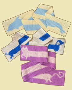 four knitted wristbands with blue and pink designs