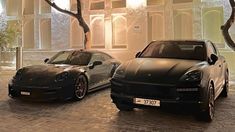 two porsches parked in front of a building