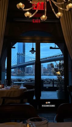 a restaurant with a view of the brooklyn bridge